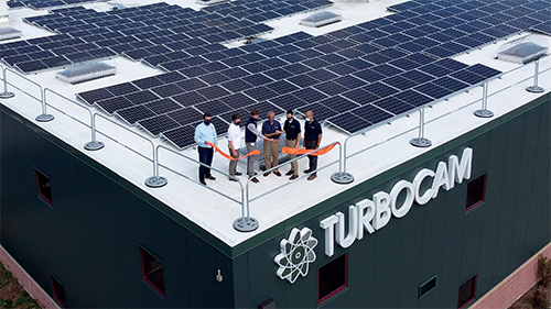 Turbocam employees cut ribbon at new office