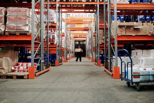 Warehouse worker stacking boxes - Nokia and Bosch.