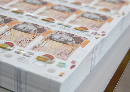 Stacks of Un-cut ten pound notes