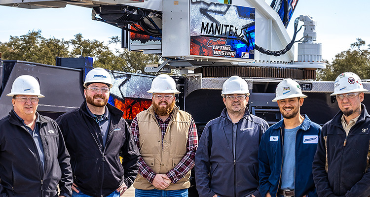 Manitex staff standing in front of a mobile crane