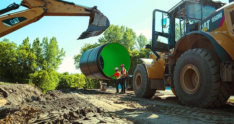Heavy plant installing large water pipe