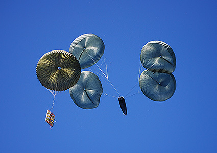 Boat being dropped by parachute