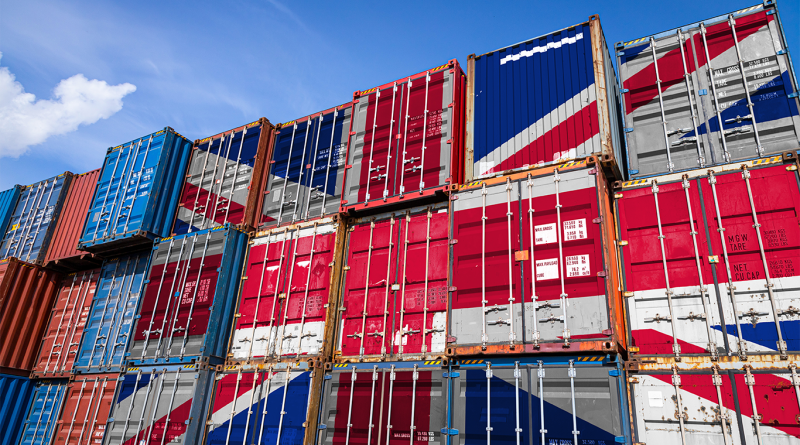 Image of various storage containers piled on top of each other with the Union Jack flag painted on them to support UK manufacturing article