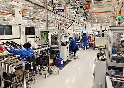 Workers inside LEM manufacturing facility