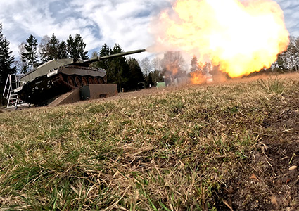 Tank firing its main gun on a testing ground