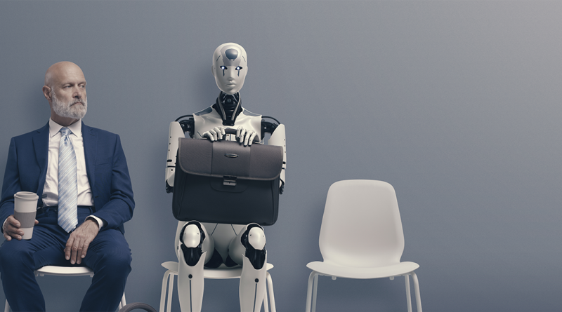 Man in workwear sat next to a robot with briefcase to support manufacturing automation article