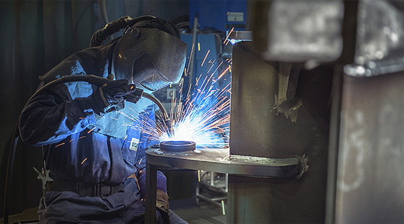 Manufacturing professional in welders protective uniform to support Miller UK article