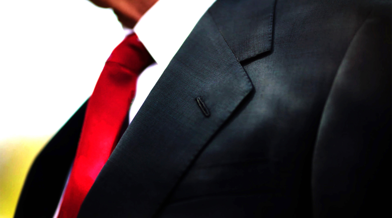 Man in suit with red tie to support Trumps tariffs article