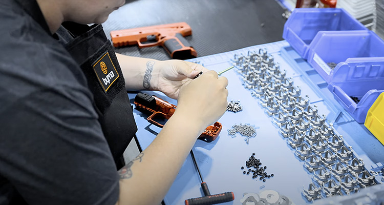 Technician assembling non-lethal firearm