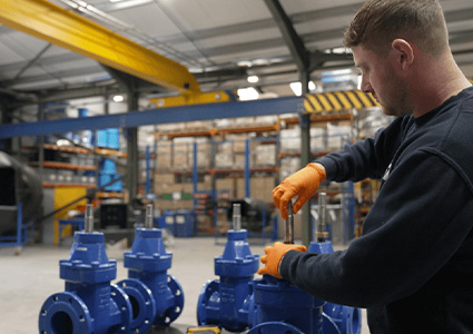 worker checking blue valves