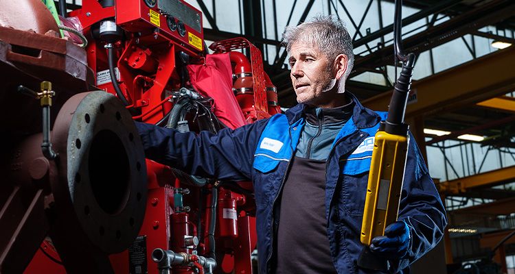 SPP umps worker working on a large red pump