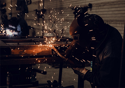 Sparks flying as welder joins two pieces of steel