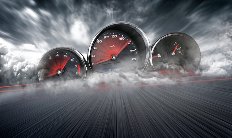 Speedometer scoring high speed in a fast motion blur racetrack background. Speeding Car Background Photo Concept.