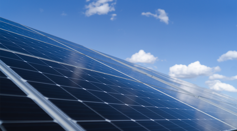 solar manufacturing panels in field under blue skies