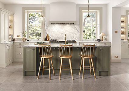 Wooden chairs around an island in a kitchen