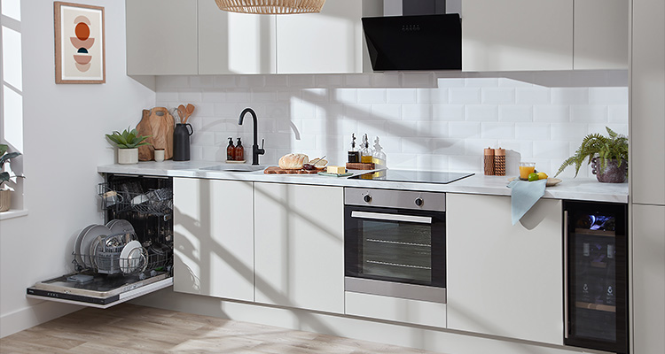 modern kitchen with white cabinets, a light countertop, and stainless steel appliances