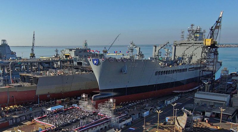 3D printing equipment fabricating naval ship parts in a manufacturing facility