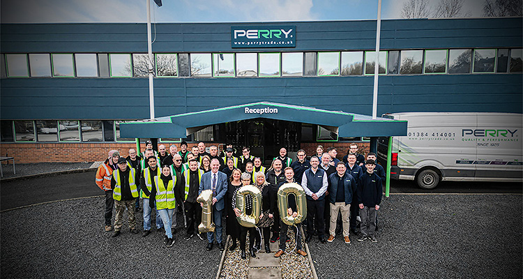 employees, posing in front of the Perry Group building