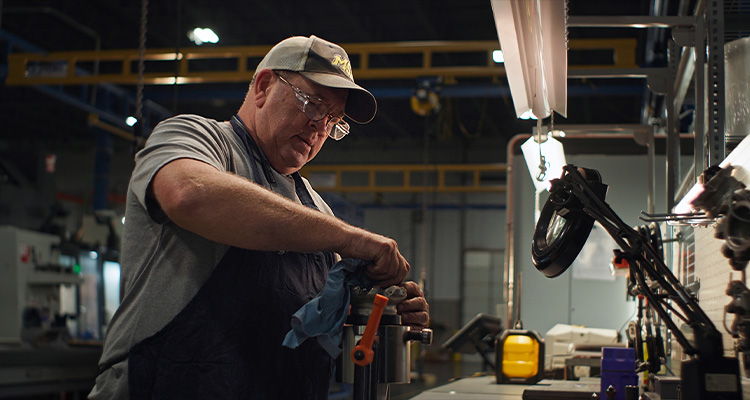 man working on machinery at United Performance Metals