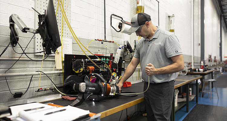 a person working with hydraulic equipment manufactured by Holmatro