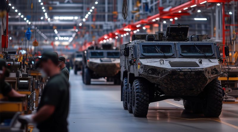 A US Navy technician inspects a metal part produced by a 3D printer in a military facility.