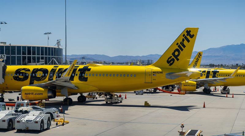 Spirit Airlines works to steady itself after turbulent year Spirit Airlines plane taxiing at a US airport during sunset with passengers boarding