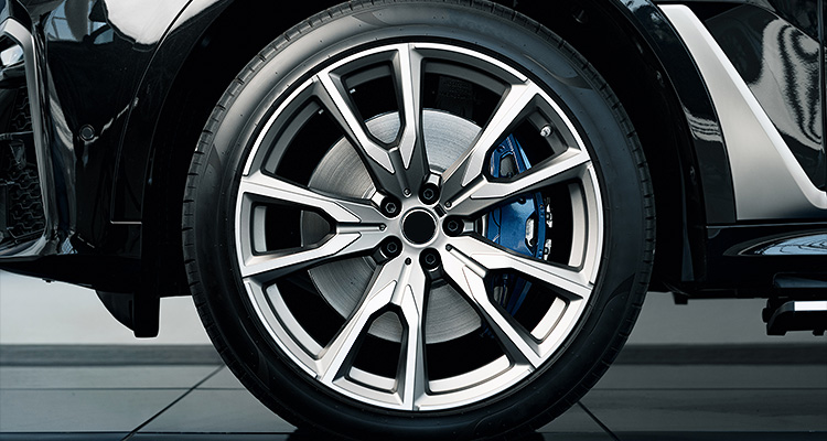 The pursuit of perfection prevails at Wolverine Advanced Materials as it continues to expand and diversify an alloy wheel with a two-tone finish and a visible blue brake caliper.