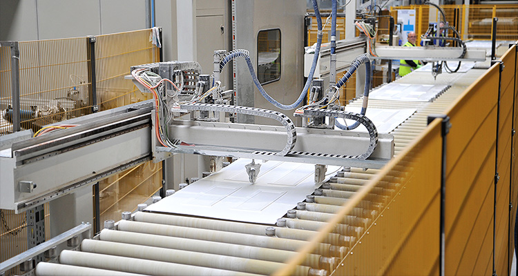 Stylish, sustainable and locally supplied: IG Doors continues to grow with its new state-of-the-art factory a manufacturing process for composite doors, featuring a robotic arm working on a door panel on a conveyor system