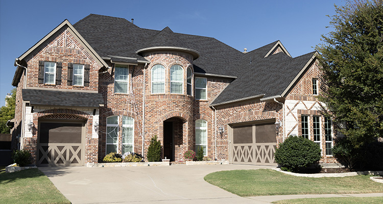 With an innovative vision, TAMKO remains at the forefront of America’s roofing industry a large, two-story brick house with multiple gables and a prominent rounded turret feature at the front entrance