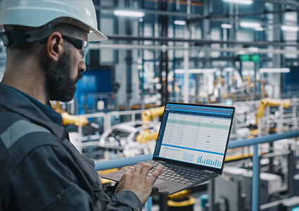 a technician or engineer working on a laptop