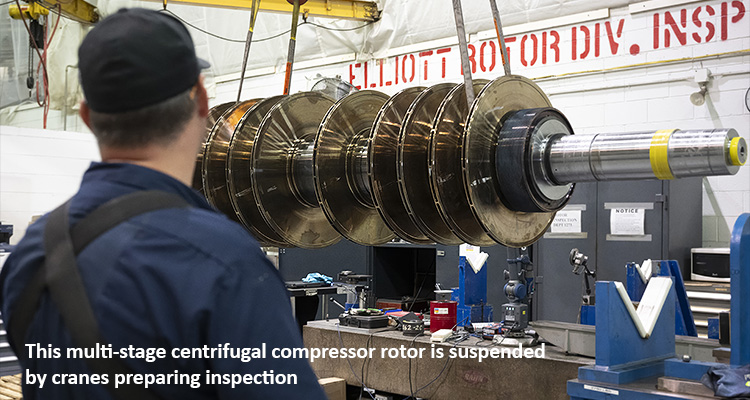 This multi-stage centrifugal compressor rotor is suspended by cranes preparing inspection