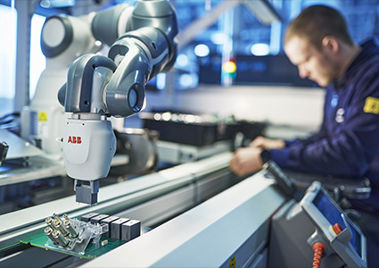 an ABB industrial robot arm working alongside a human operator
