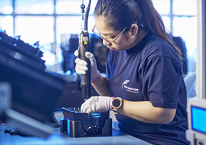 a person working on assembling a technical component