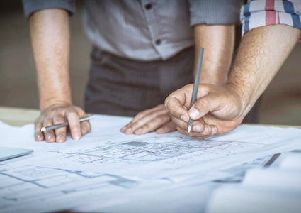 professionals reviewing architectural blueprints