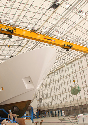 an overhead crane in a yacht manufacturing facility