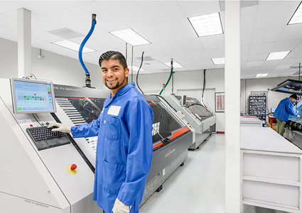 a technician working in a modern electronics manufacturing facility.
