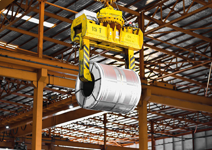 a steel coil being lifted by an industrial overhead crane