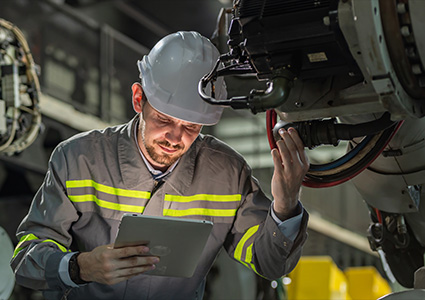 an industrial engineer or technician inspecting machinery