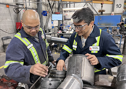technicians repairing industrial machinery in a workshop