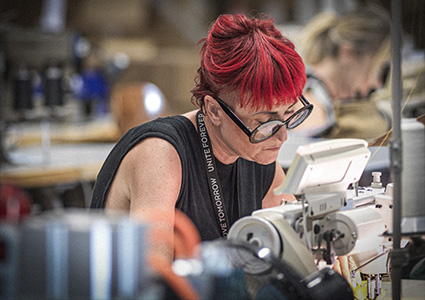 a person focused on industrial sewing work