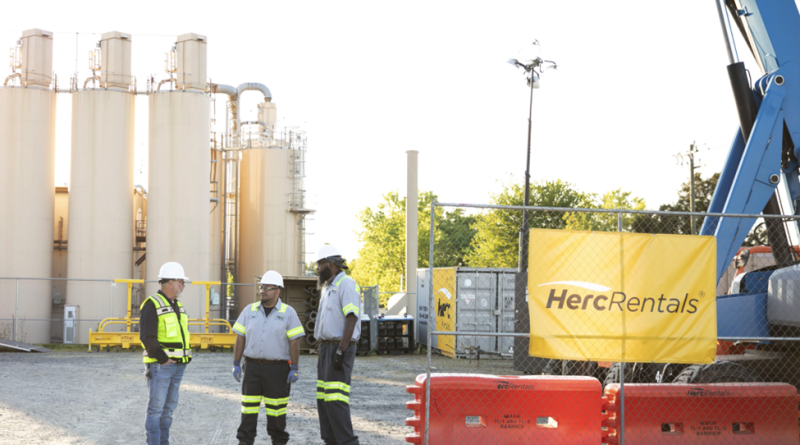 Herc Rentals team outside factory