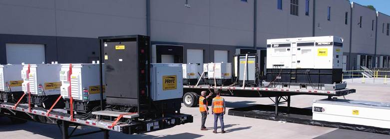 Herc Rentals team outside factory
