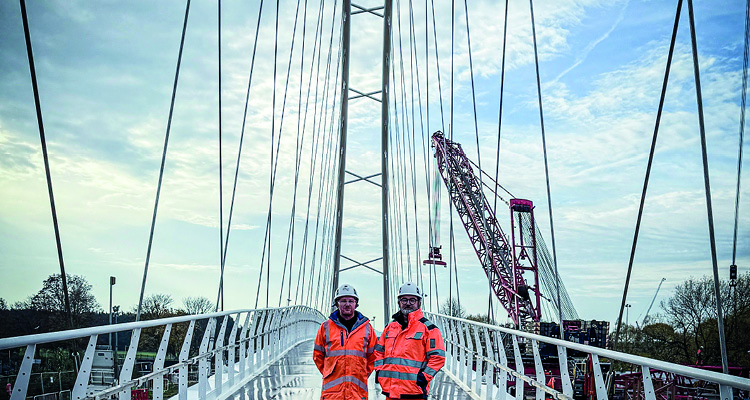 a construction scene, likely featuring a cable-stayed bridge