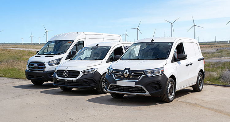 a line of white commercial panel vans