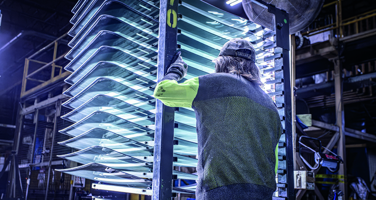 worker handling automotive glass