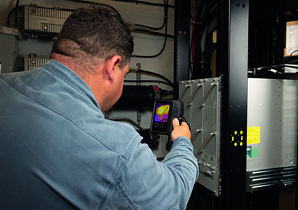 a FLIR iXX-Series thermal imaging camera being used to inspect electrical equipment.