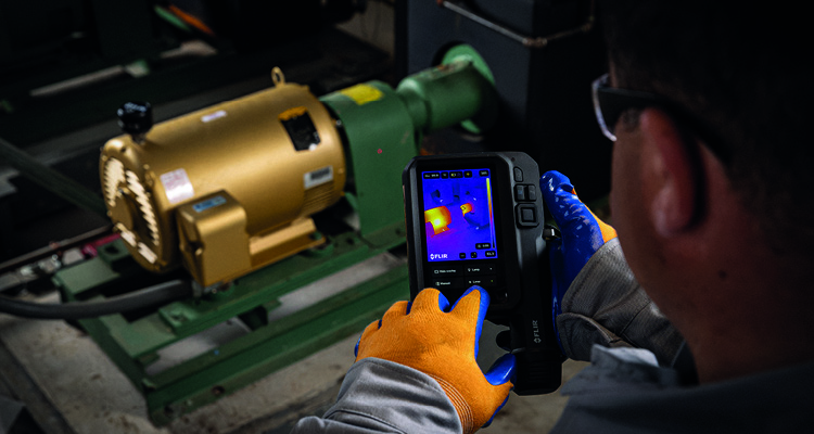 a person using a FLIR thermal camera from the iXX-series