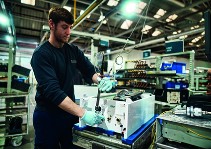  technician working on electrical equipment in a factory or workshop