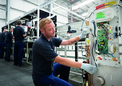  male technician working on an assembly line or in a maintenance facility