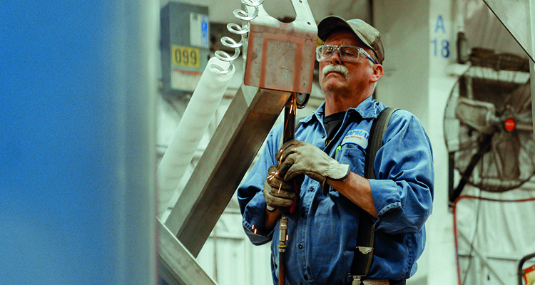 a man working in what appears to be an industrial or manufacturing setting